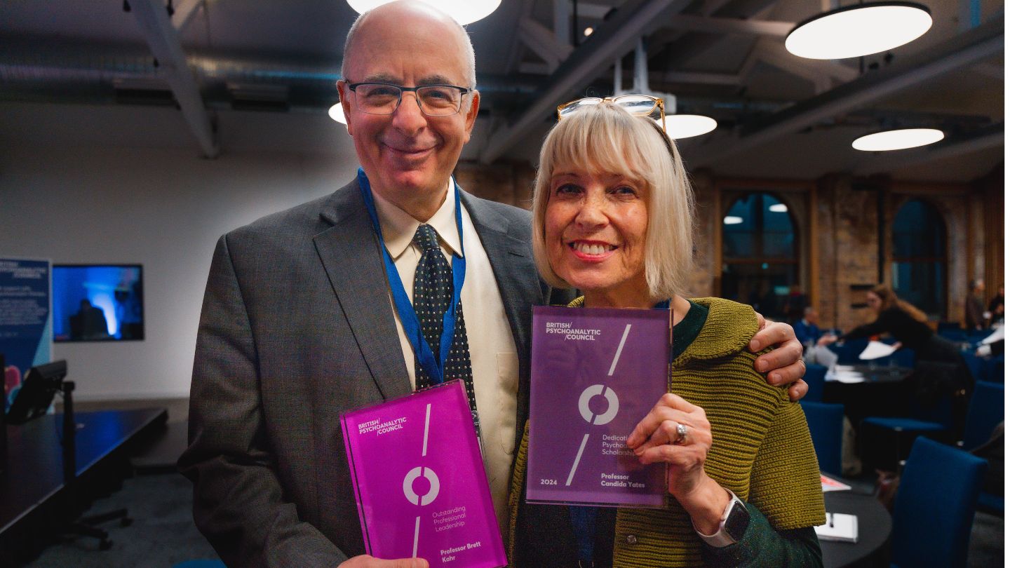 Man and woman standing side by side holding PPNow Awards.